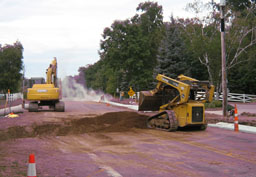 Kadlec Excavating fills with dirt. (close up)